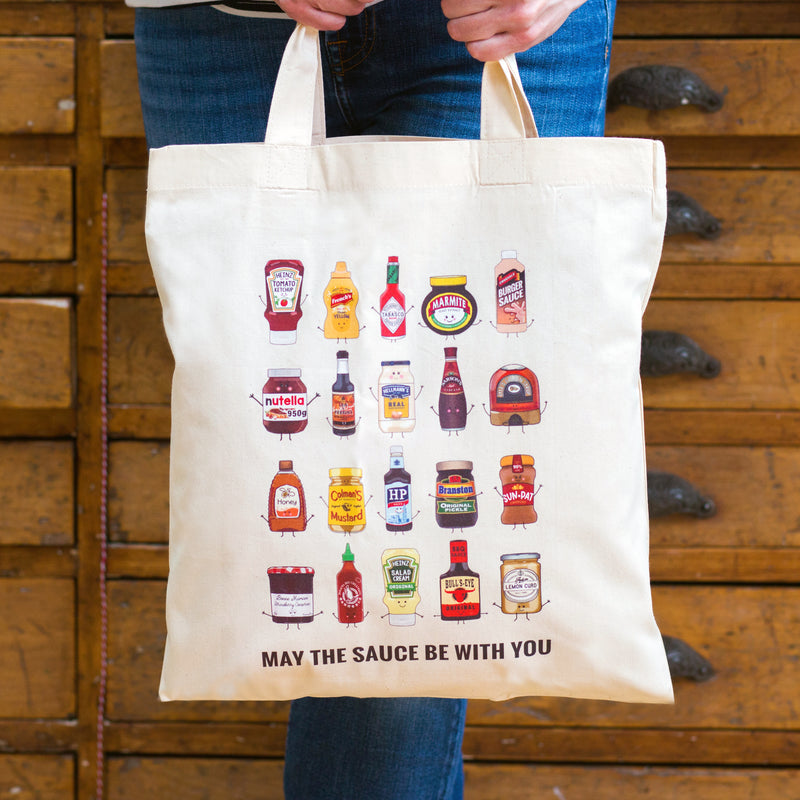 funny 100% cotton tote bag featuring illustrations of sauces and condiments and the funny pun 'may the sauce be with you'
