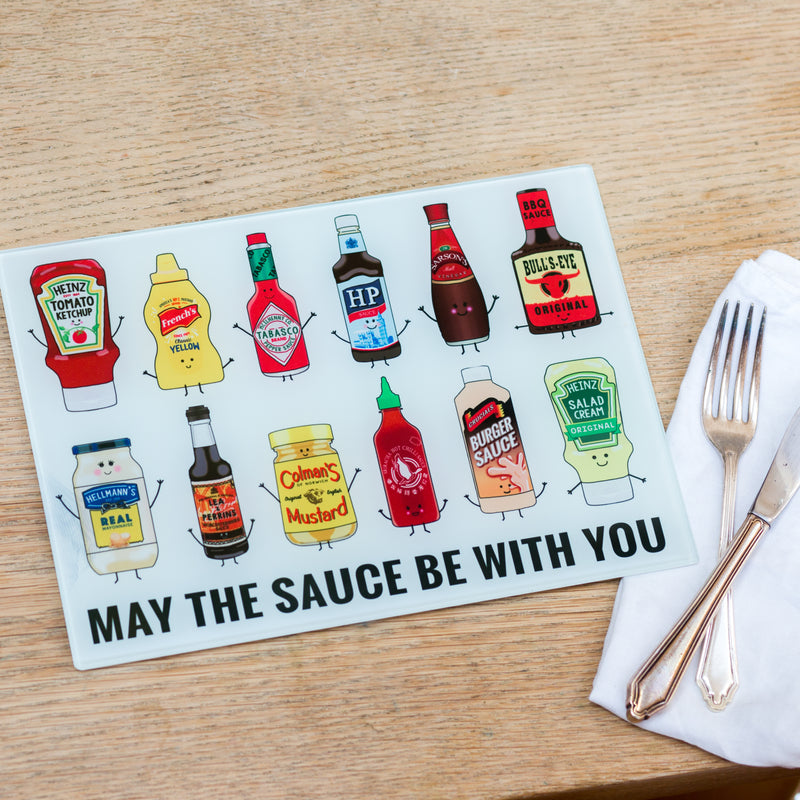 glass chopping board saying 'may the sauce be with you' and with bright illustrations of various sauces