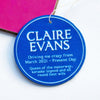 A car air freshener designed to look like an English Heritage blue plaque with personalised details