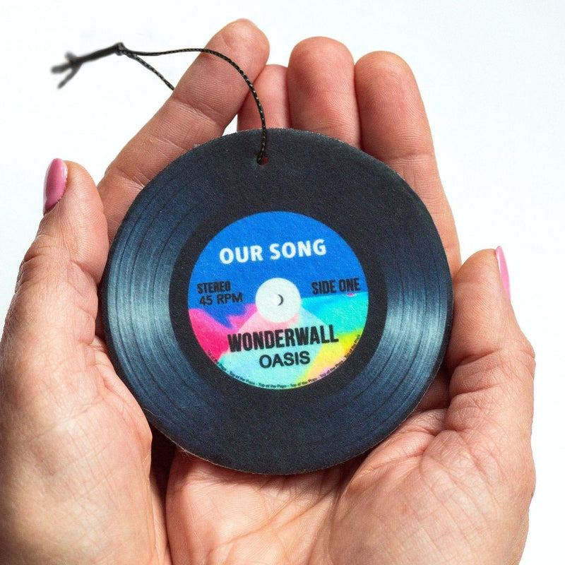 A customised car air freshener designed to look like a vinyl record and personalised with a special song